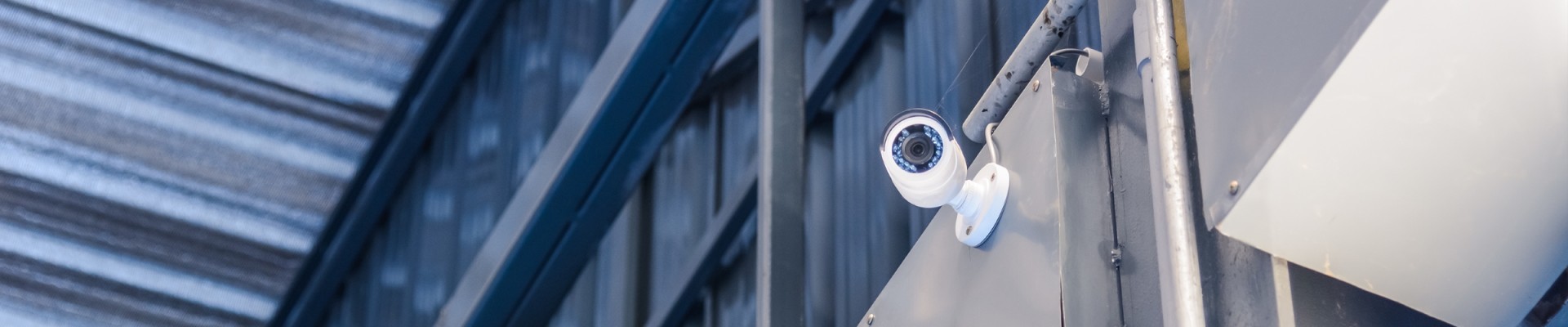 Modern security camera in warehouse