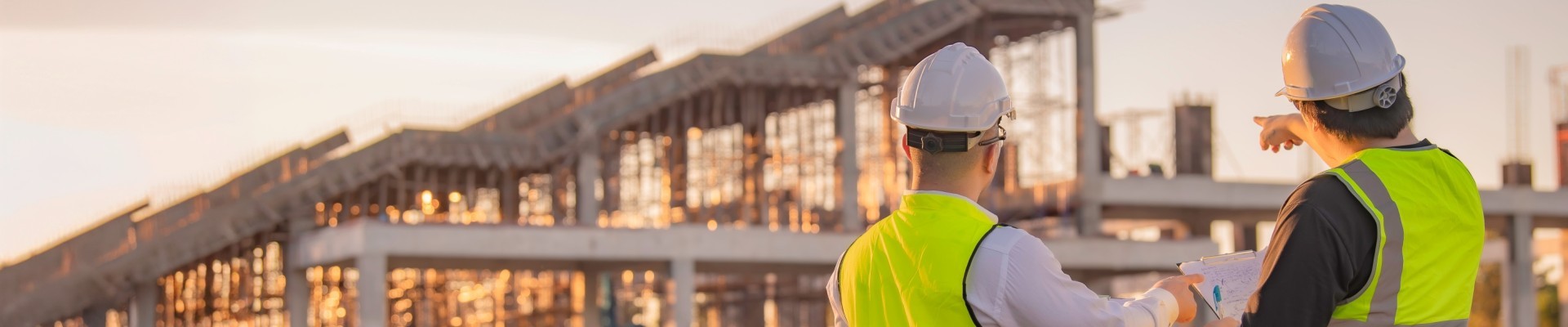 Two Asian engineer working at site of a large building project,Thailand people,Work overtime at construction site,Team of engineer discus at site