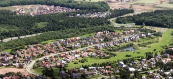 aerial view of a posh housing estate of executive detached houses built on green belt land in England