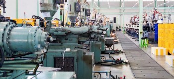 Row of machines on production floor at a factory for business and industrial concept background 