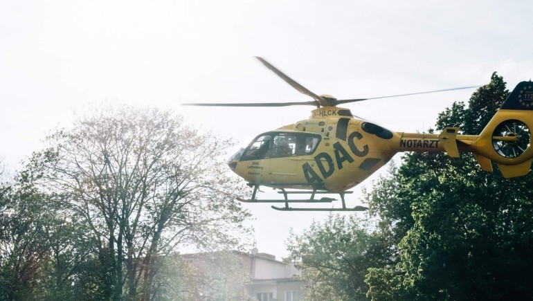 yellow helicopter lands in town scaled