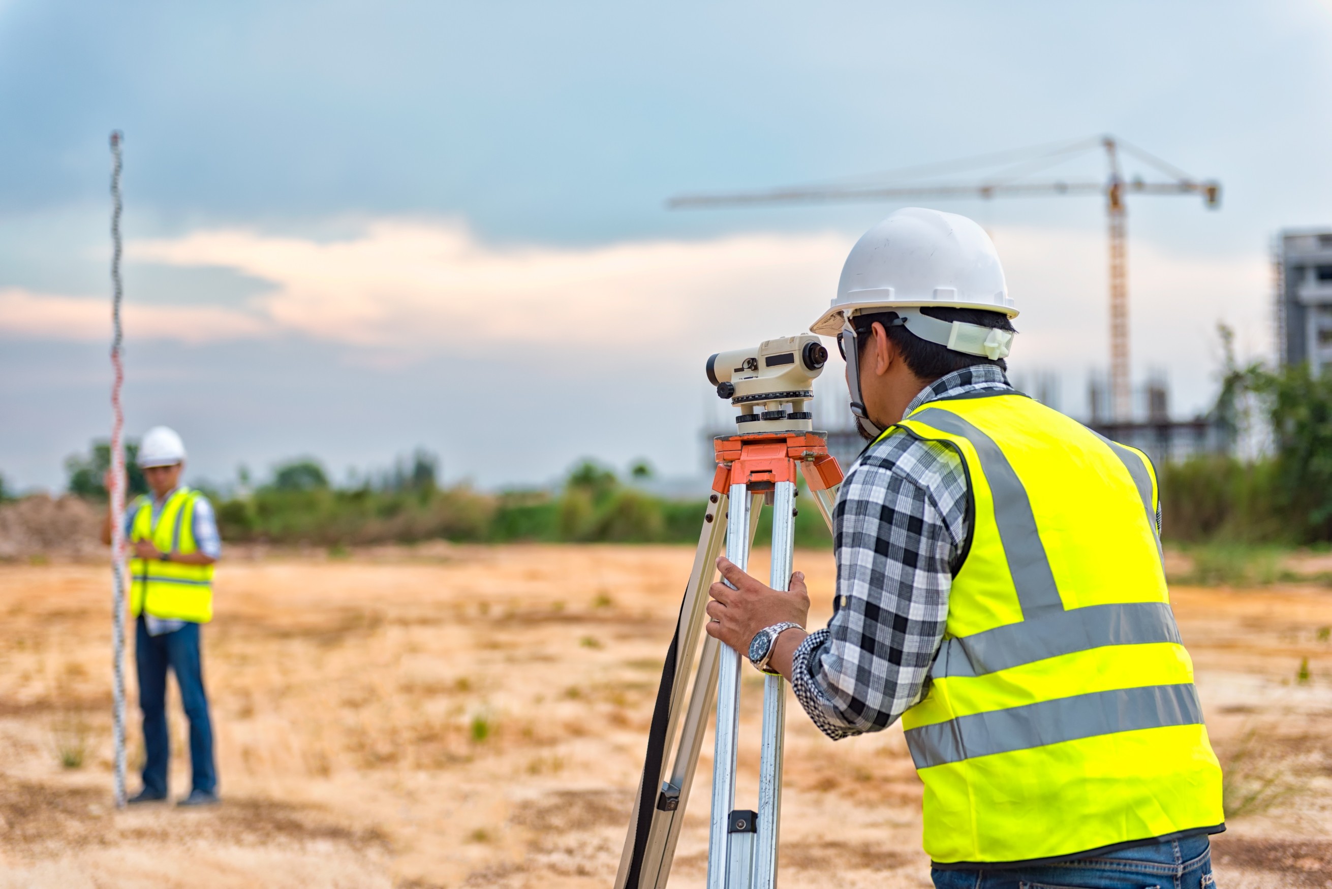 Surveyor Engineering  Surveyor’s telescope at construction site  Surveying for making contour plans are a graphical representation of the lay of the land before startup construction work