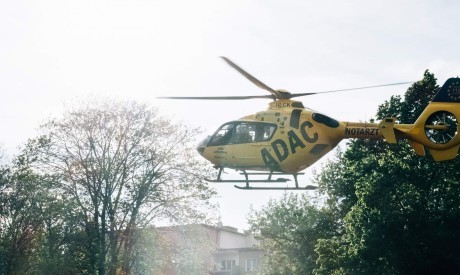 yellow helicopter lands in town scaled
